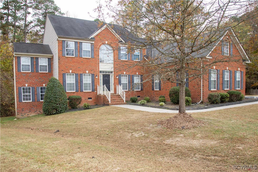 Colonial-style house with a front yard