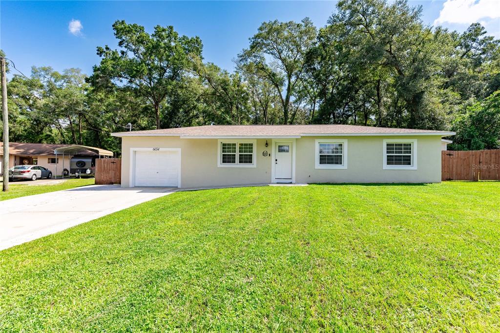 a view of a house with a backyard