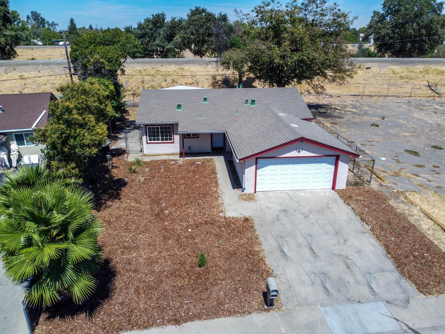 an aerial view of a house with a yard and a garage