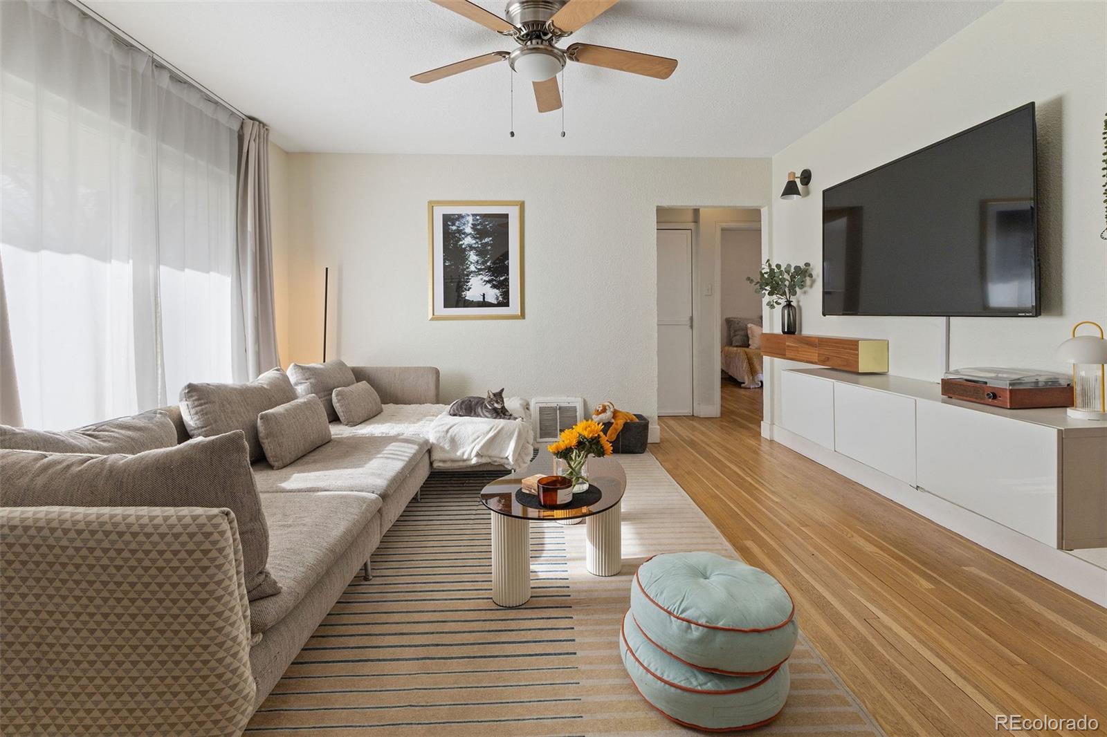 a living room with furniture and a flat screen tv