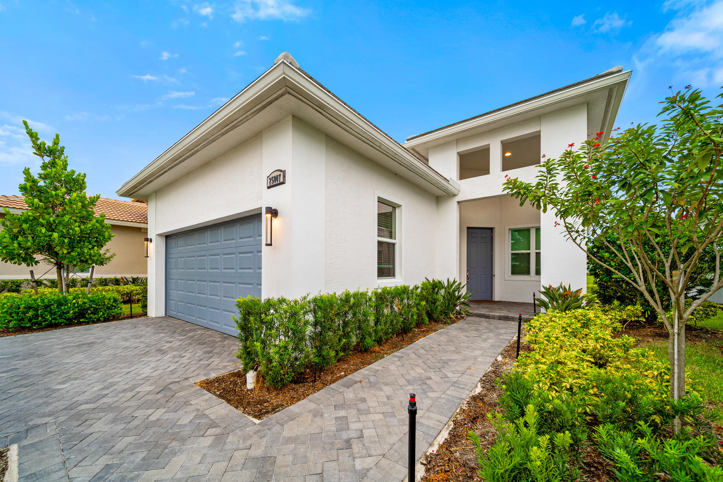 a front view of a house with garden