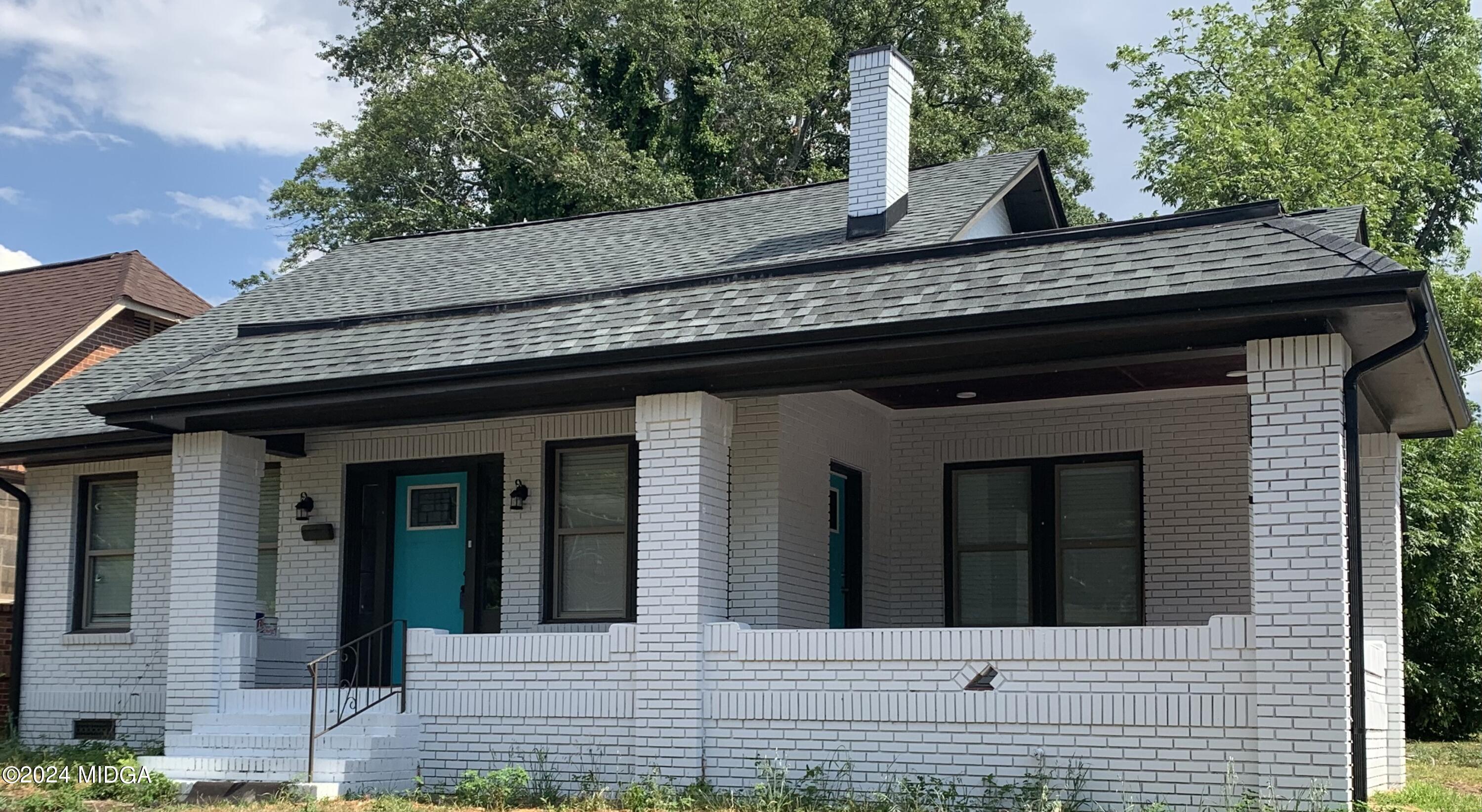 a view of a brick house with large windows