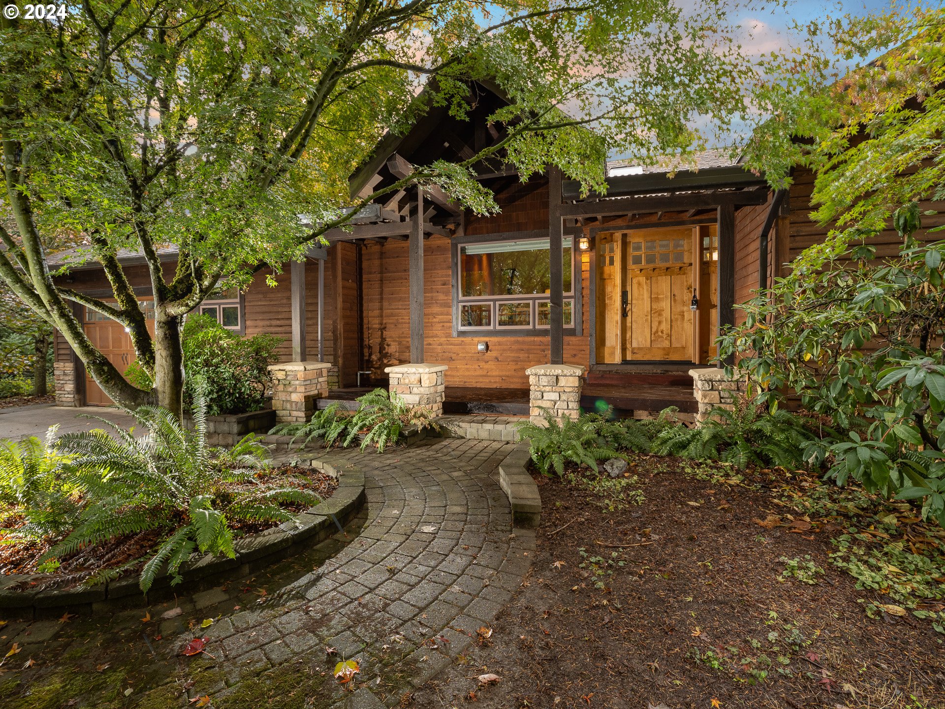 a front view of a house with garden