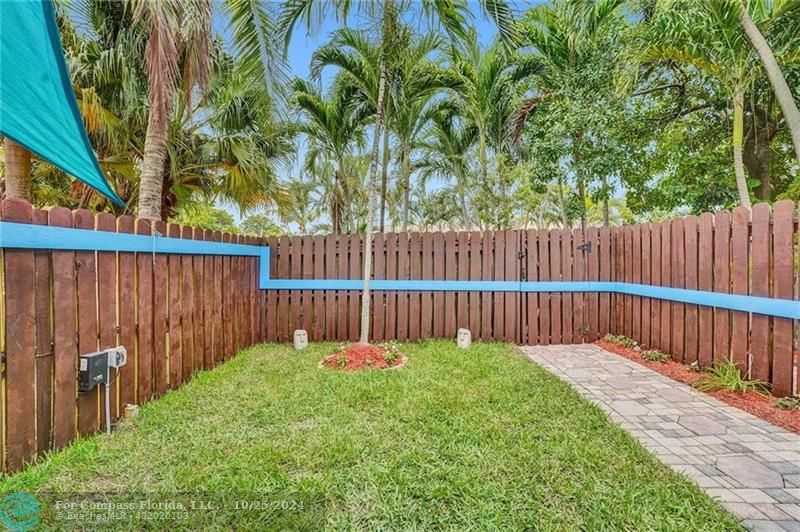 a view of a deck with a large trees and wooden fence