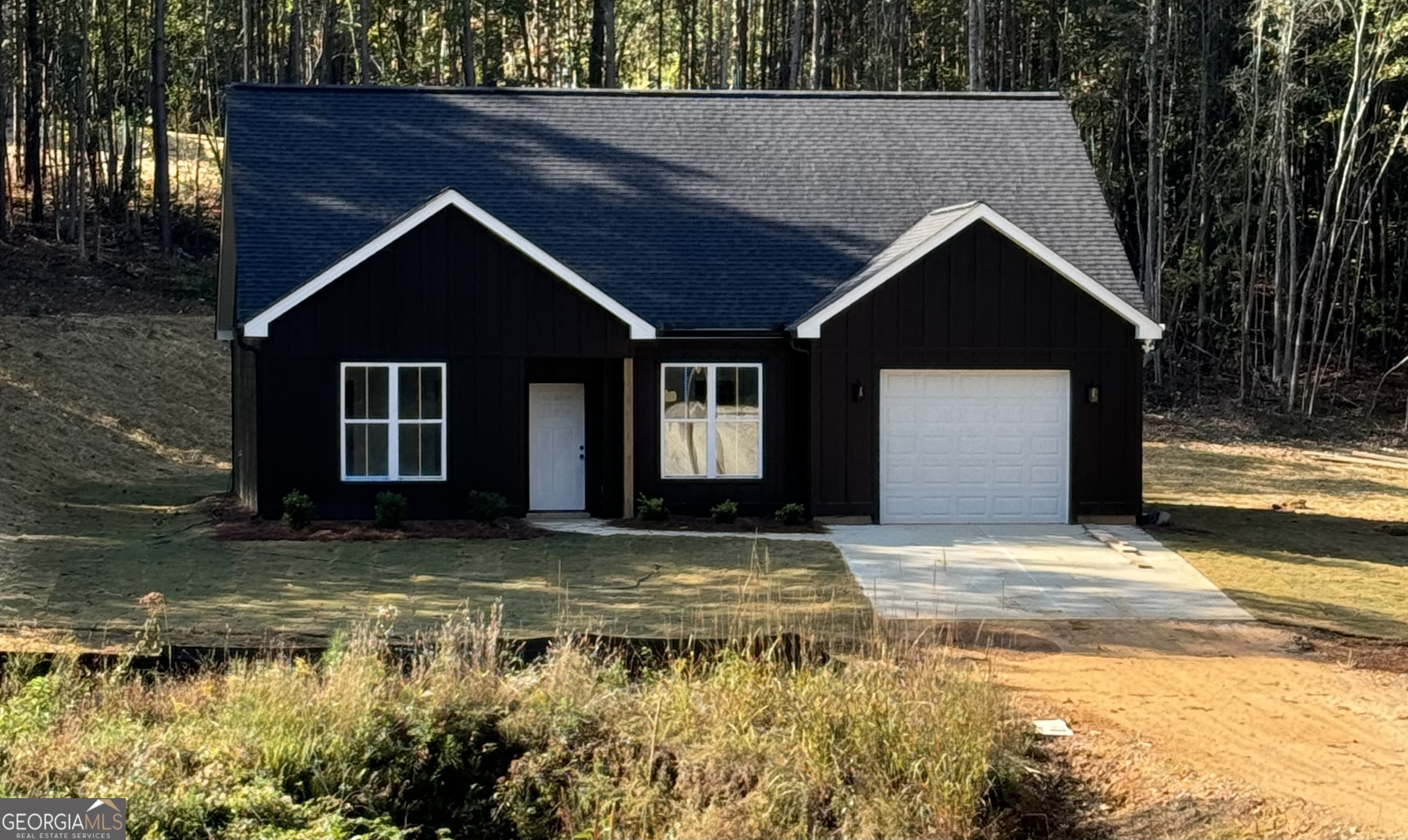 a view of house with yard in front of it