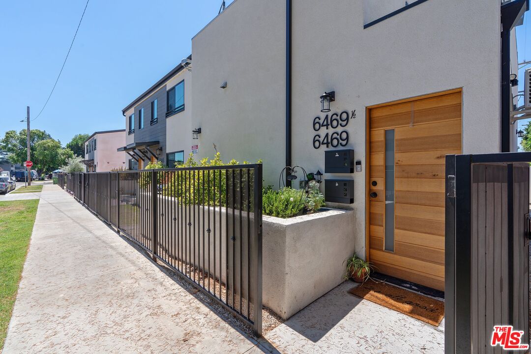 a view of a house with wooden fence