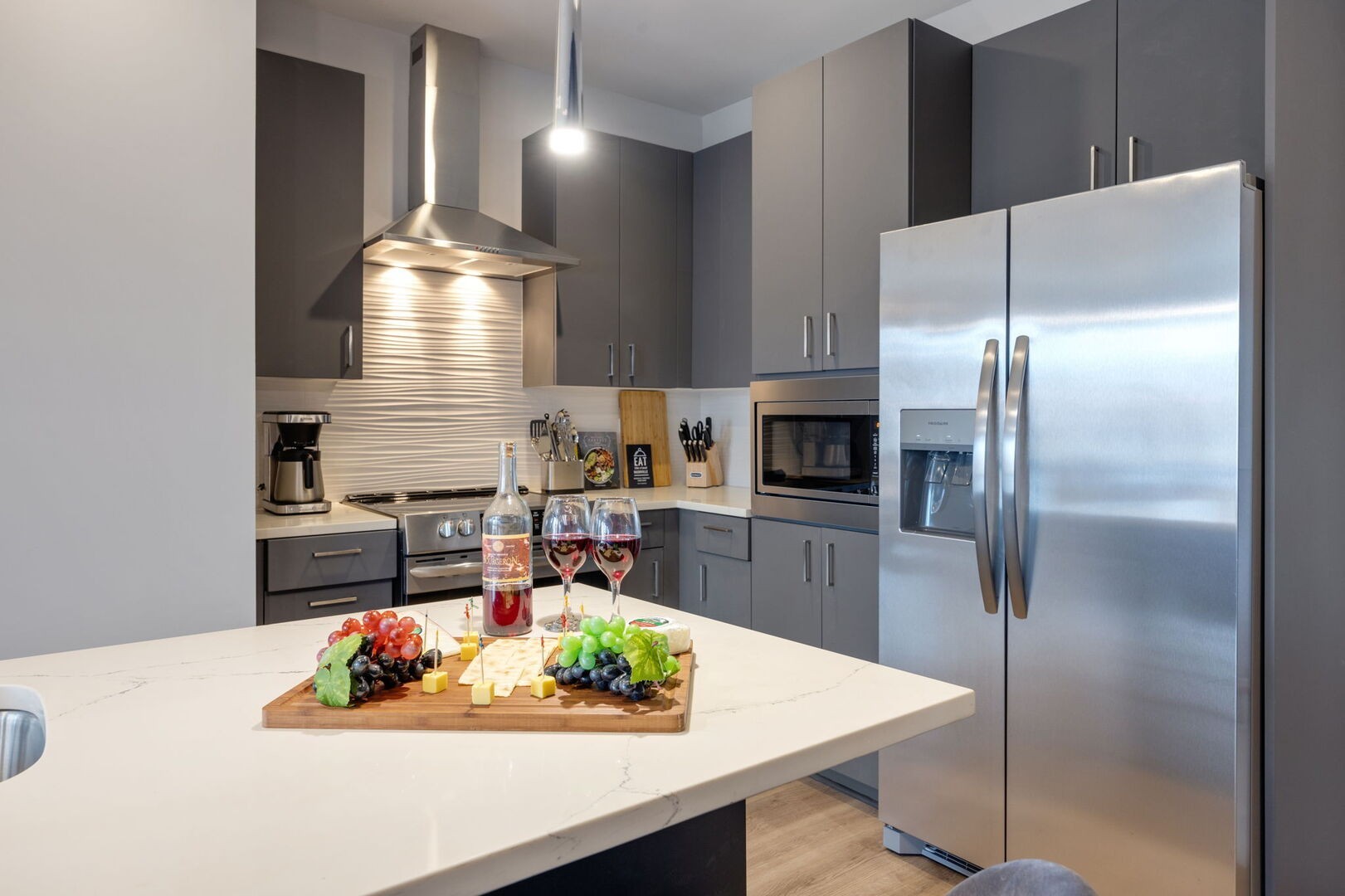 a kitchen with stainless steel appliances granite countertop a sink refrigerator and microwave