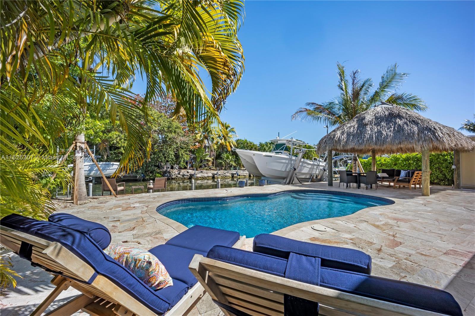 a view of a backyard with swimming pool