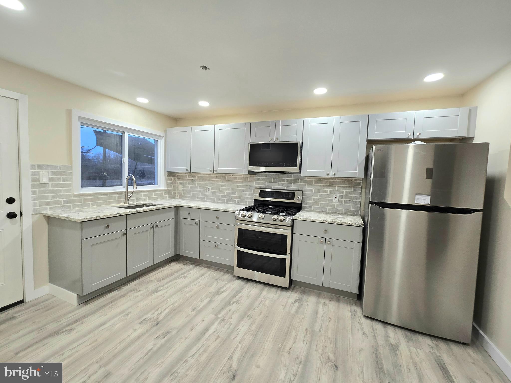 a kitchen with a refrigerator stove and microwave