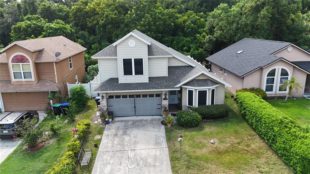 a aerial view of a house next to a yard