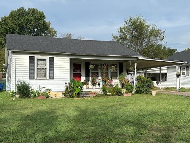 a front view of house with yard and green space