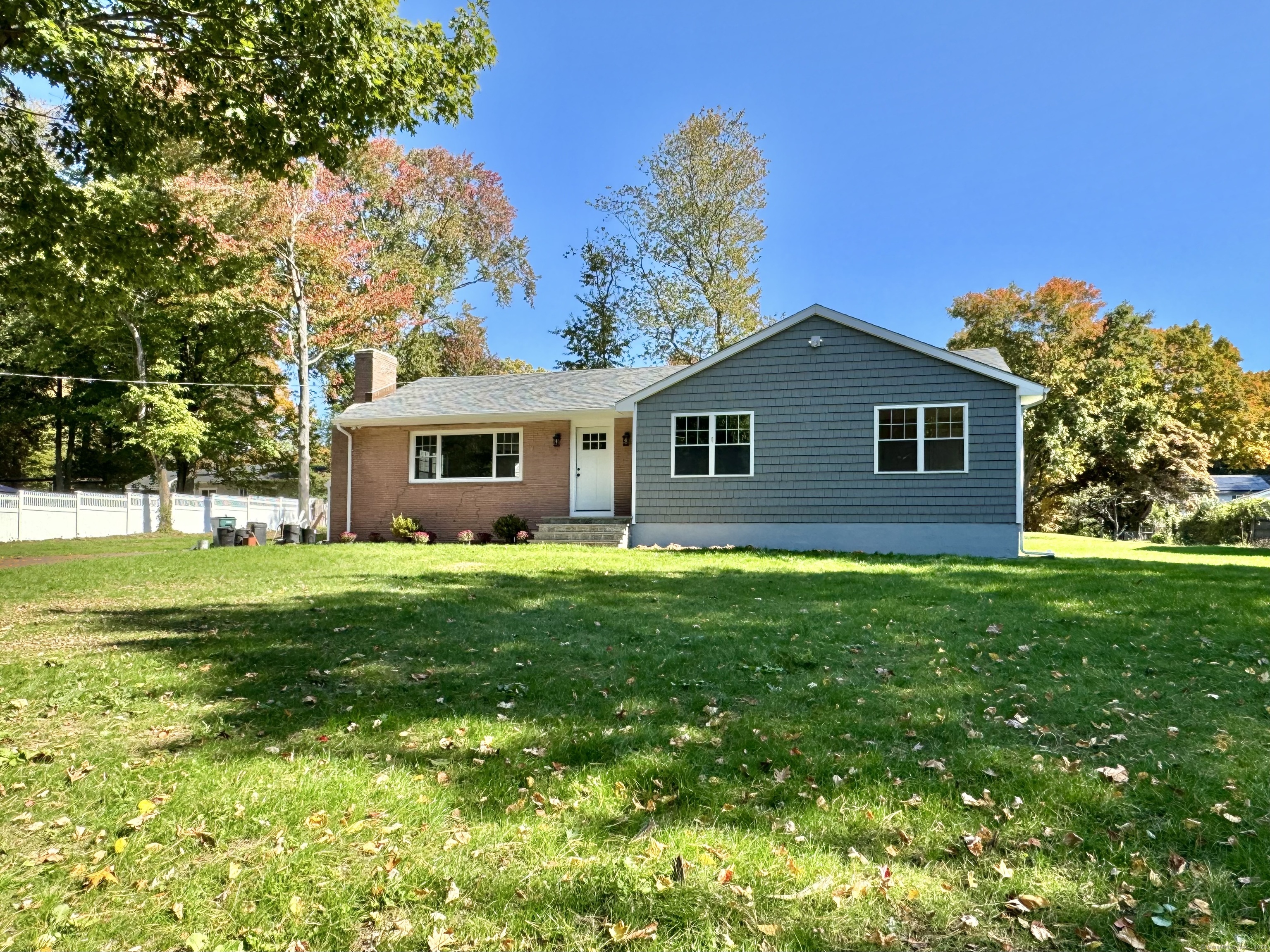 a view of a house with a backyard