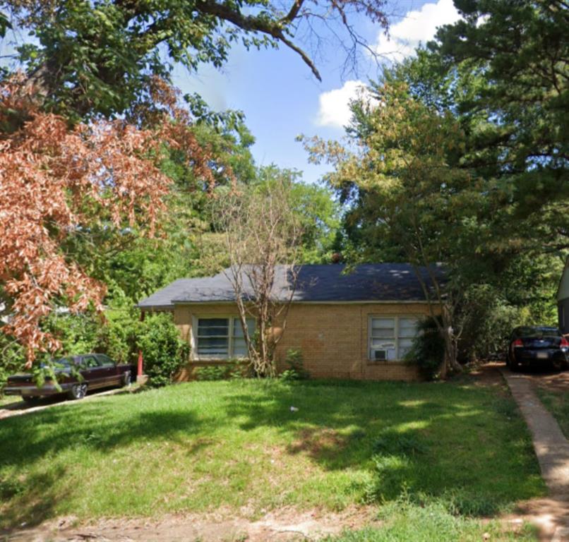 a front view of house with a garden