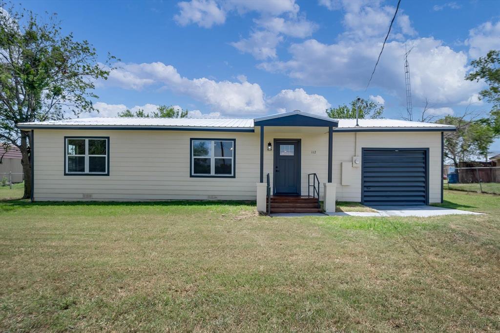 a view of a house with a yard and garage