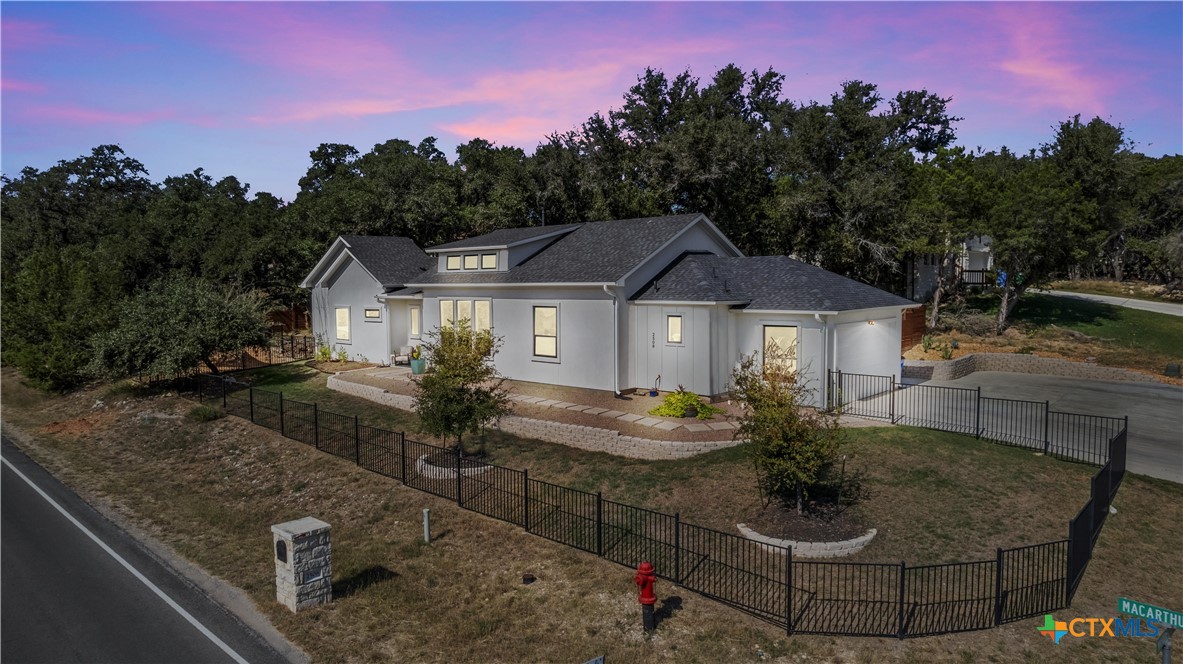 a front view of house with yard seating and green space