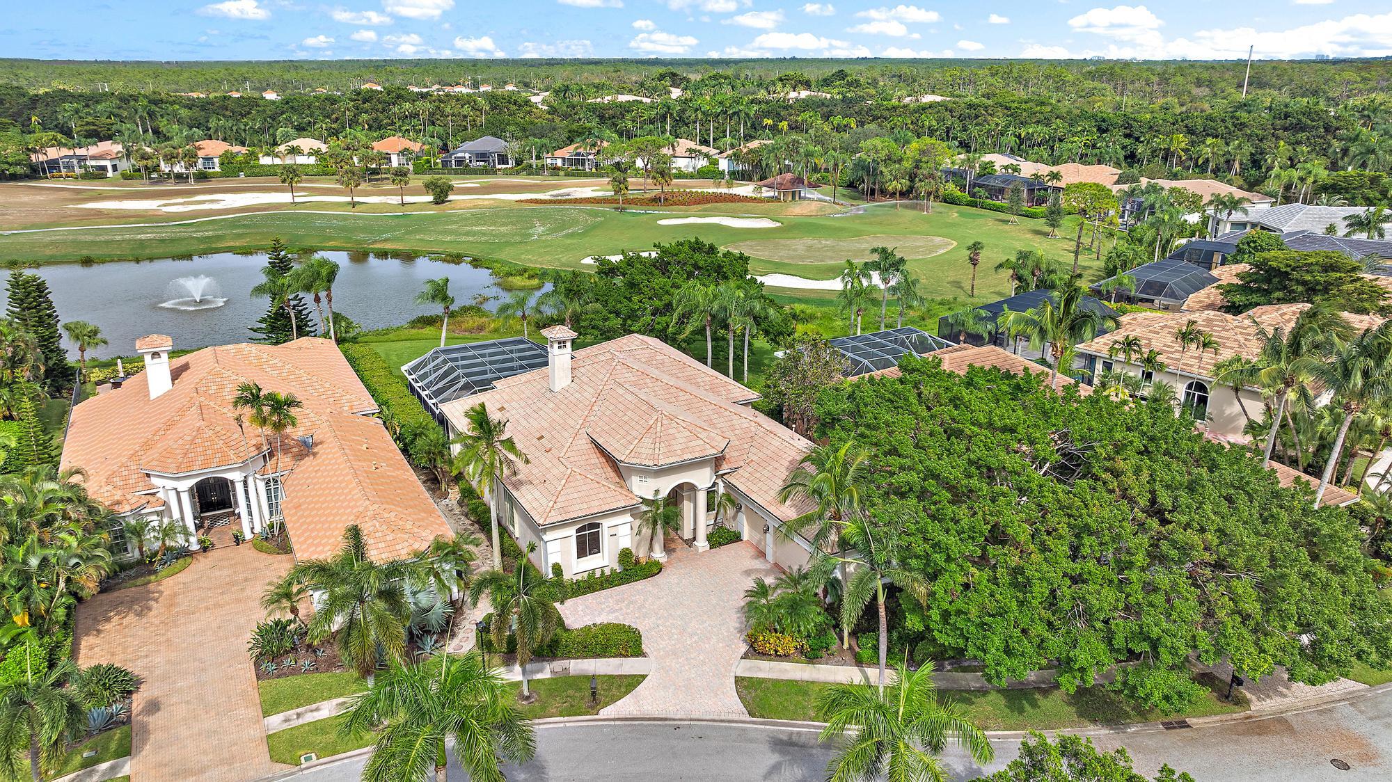 an aerial view of residential houses with outdoor space and river