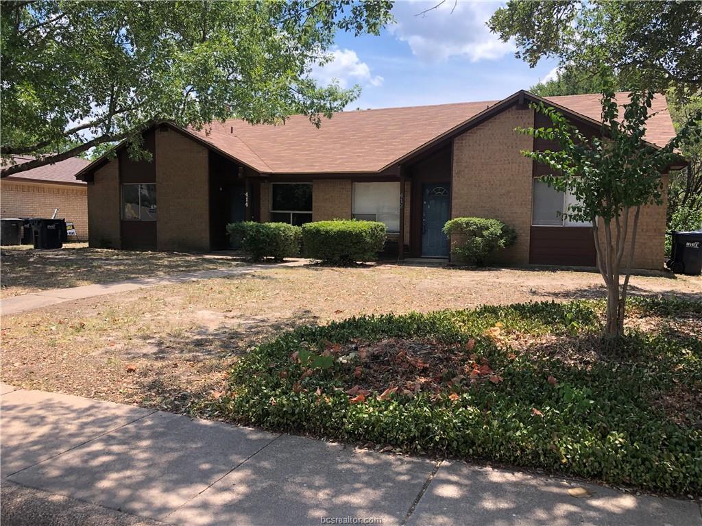 a house that has a tree in front of it