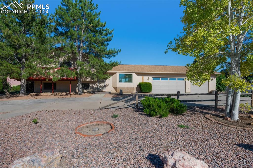 a view of a house with backyard and a tree