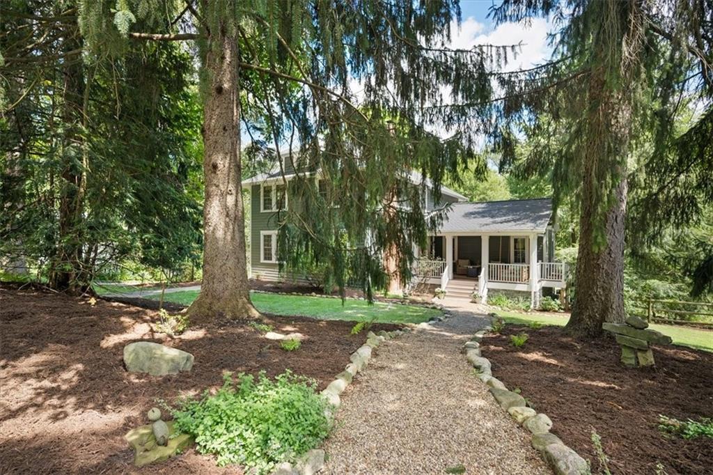 a view of a house with a tree in front of it