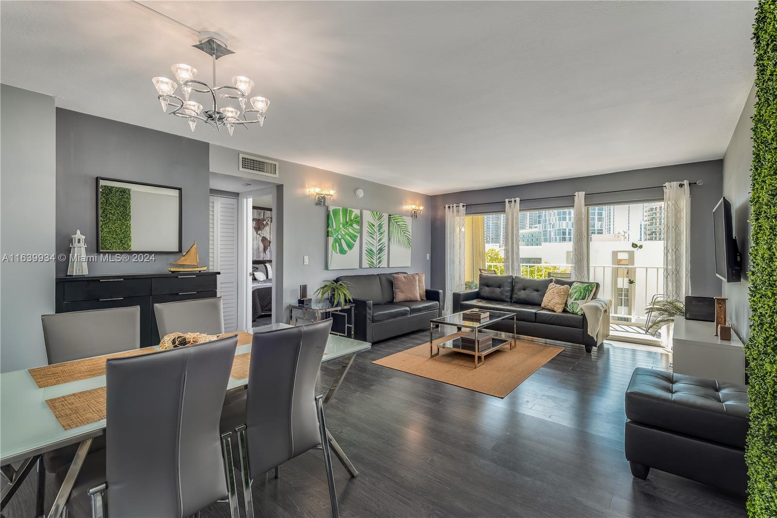 a living room with furniture and a chandelier