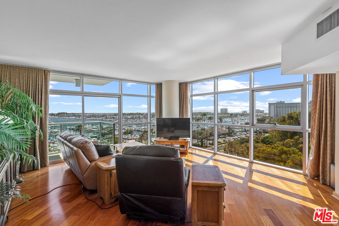 a living room with furniture and a floor to ceiling window