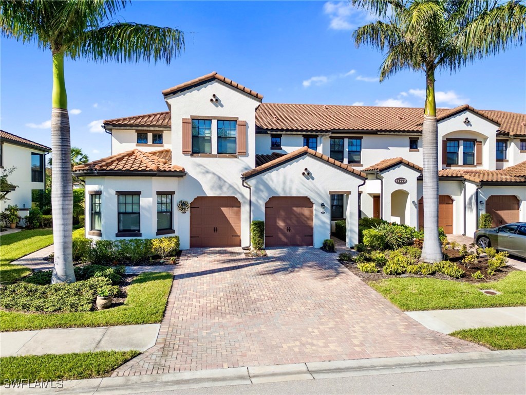 a front view of a house with garden and entryway