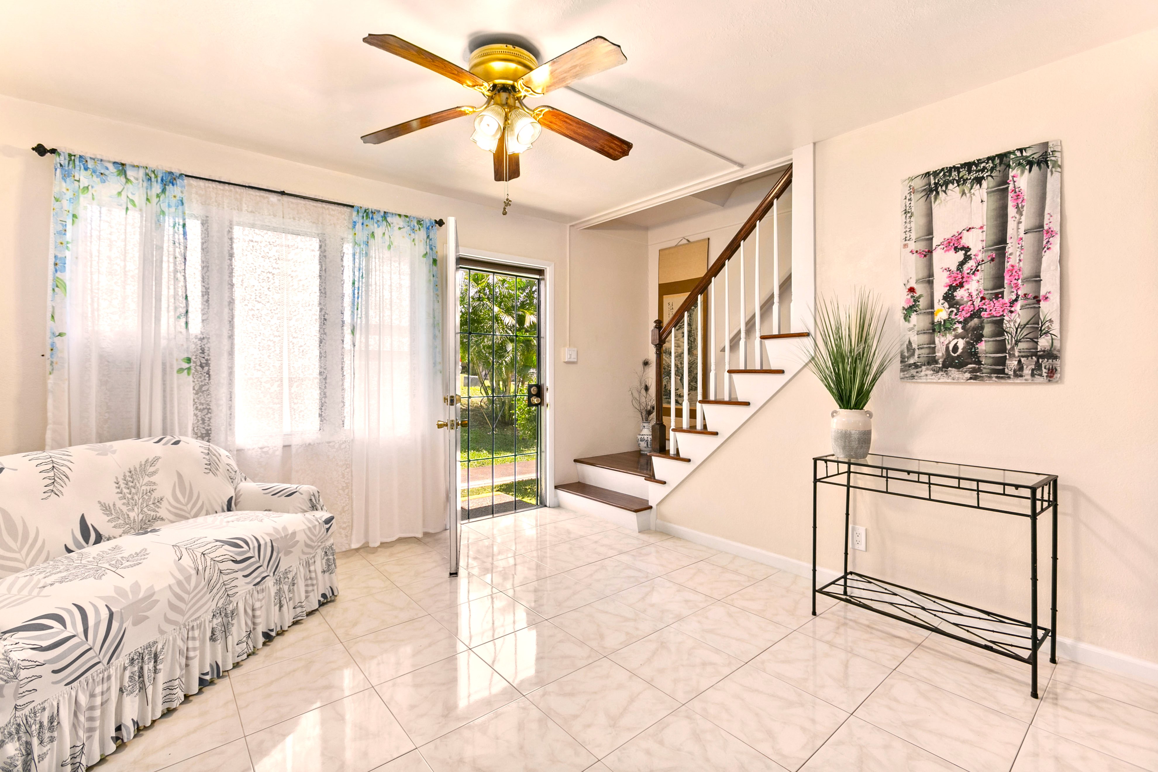 a living room with furniture and a chandelier