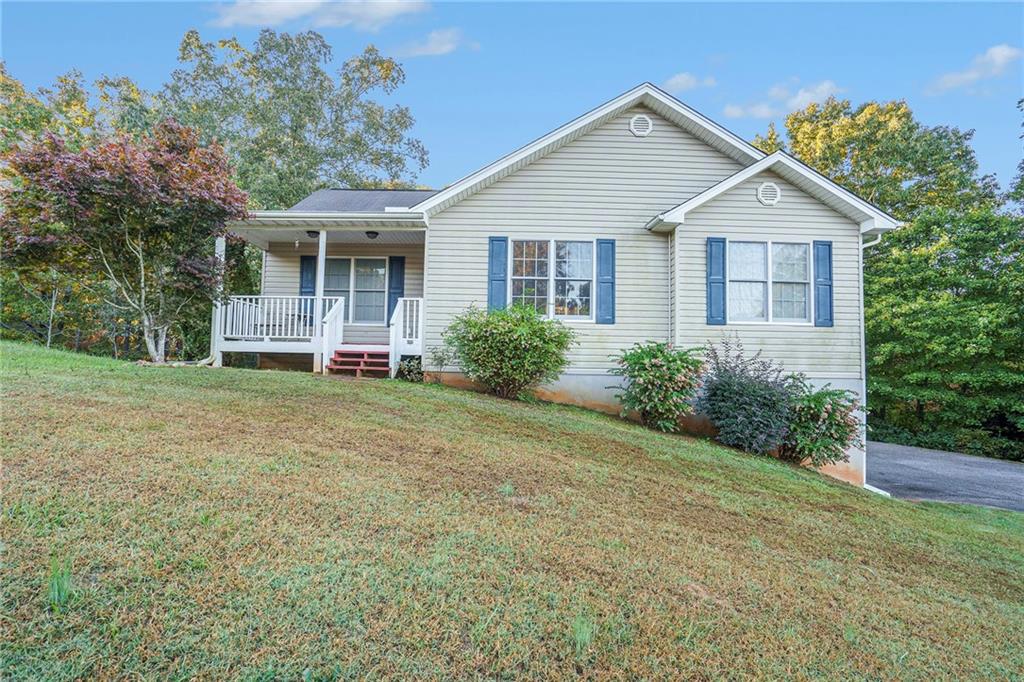 a front view of house with yard and green space