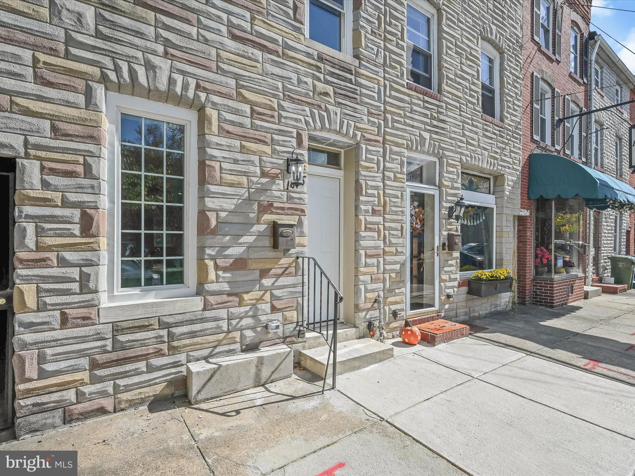 a view of house with door and outdoor seating