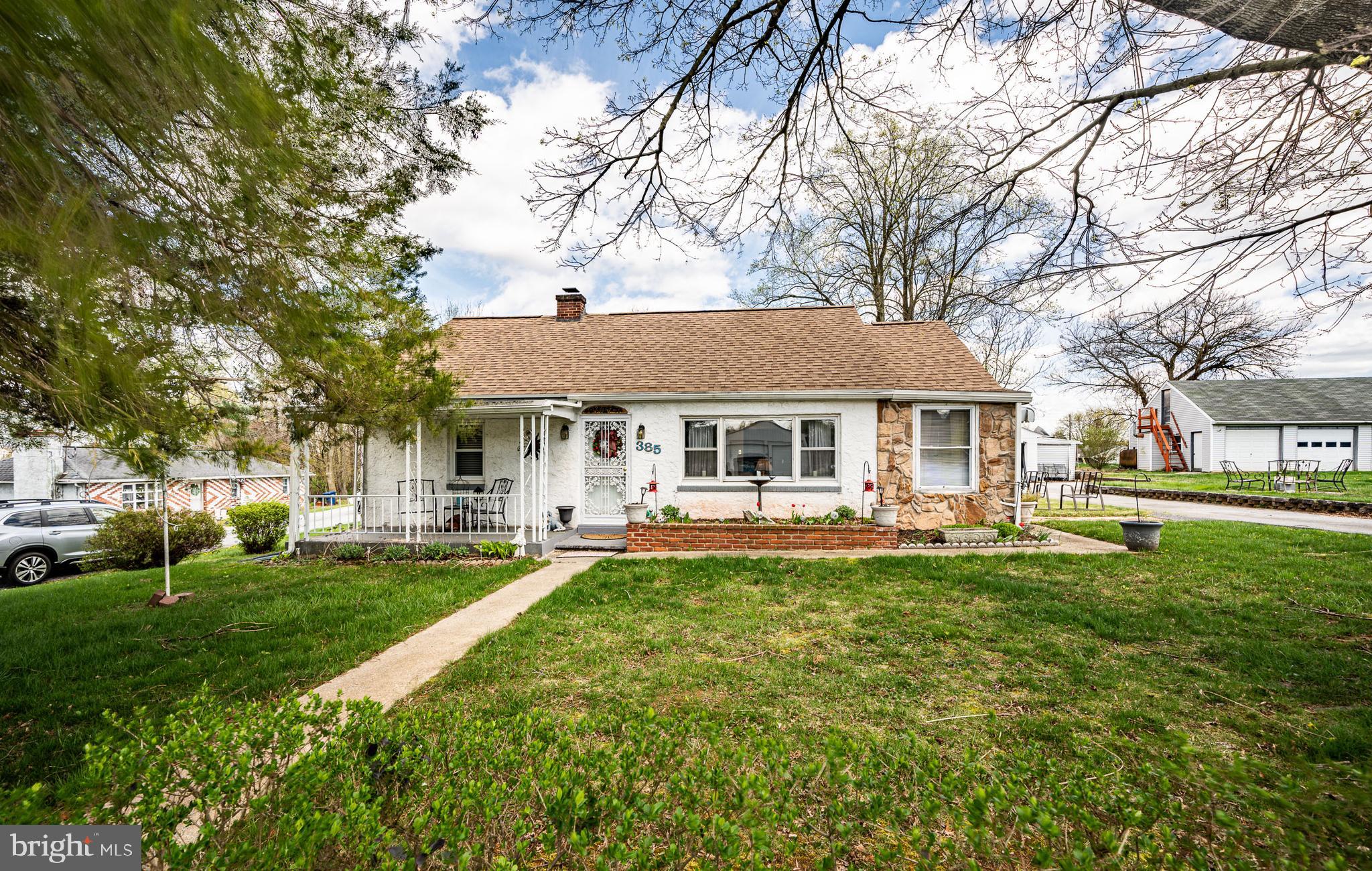 a front view of a house with yard patio and green space