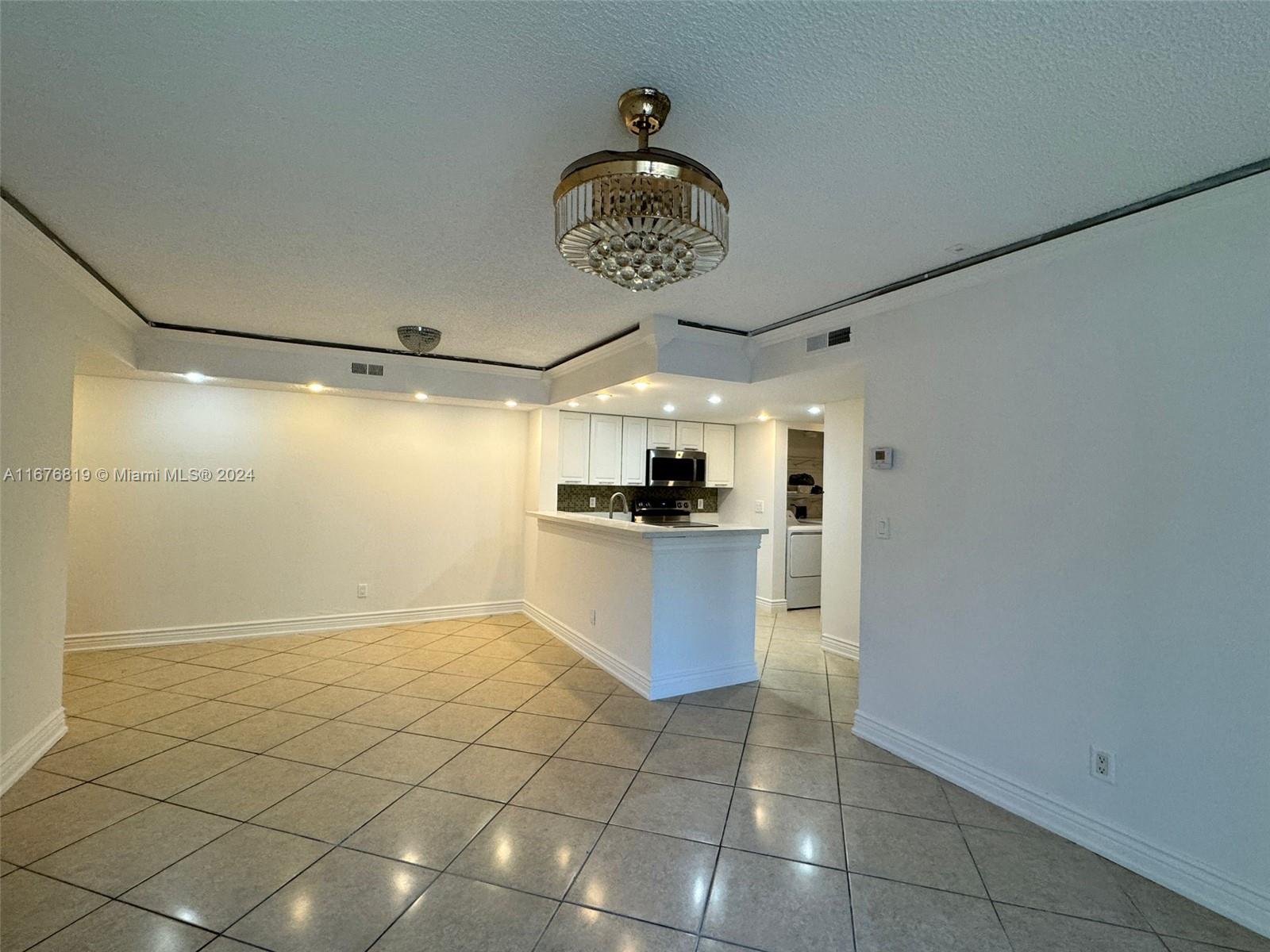 a view of kitchen with stainless steel appliances a sink and cabinets