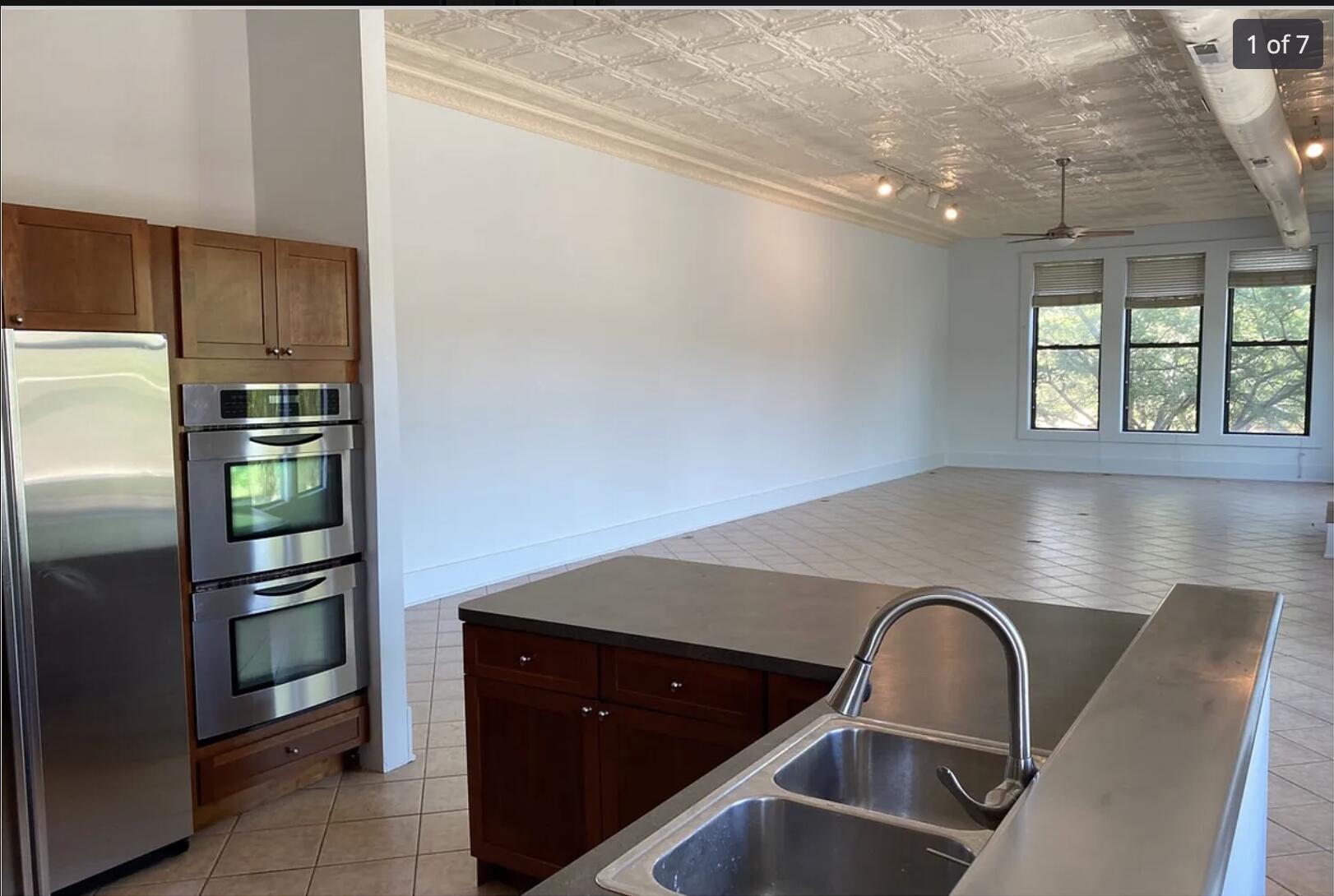 a kitchen with a refrigerator and a sink