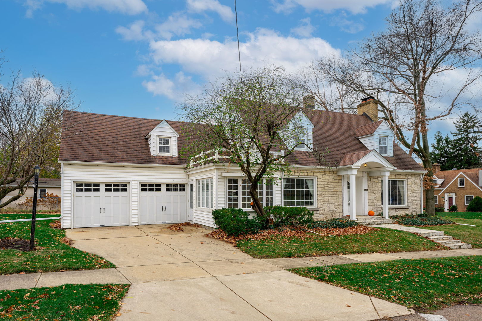 a large house with a big yard and large trees