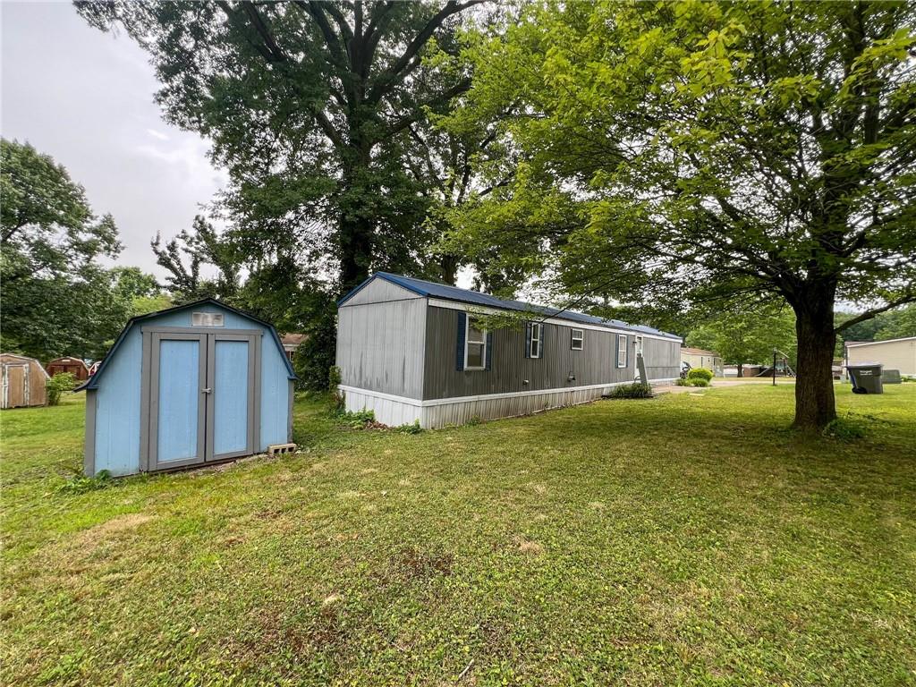 a view of a barn in the middle of a yard