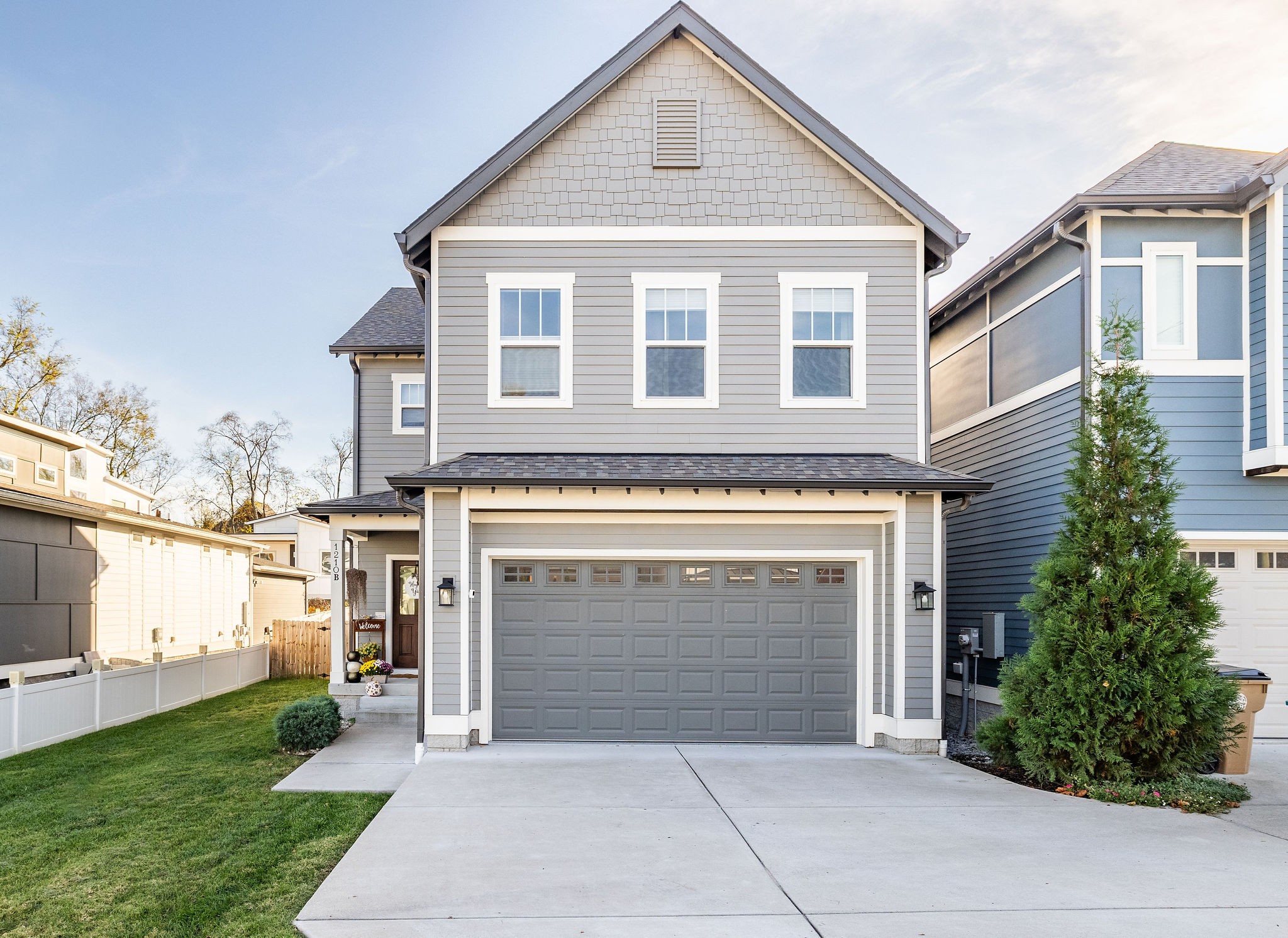 a front view of a house with yard and parking