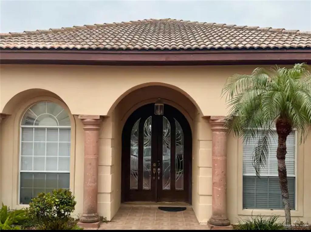 a front view of a house with plants