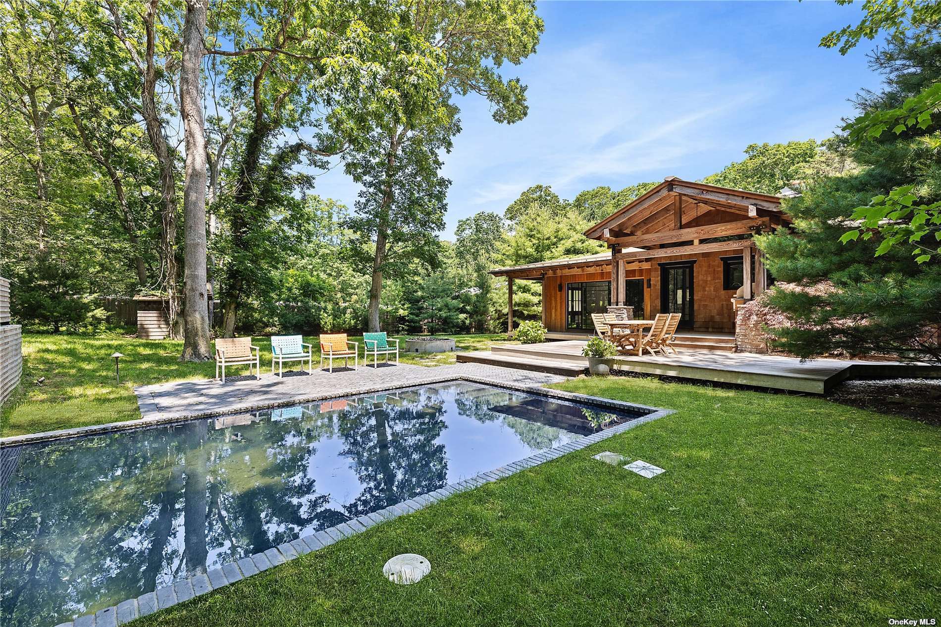 a view of a house with swimming pool and a yard