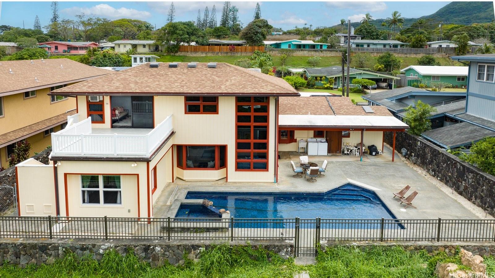 a aerial view of a house with a yard and lake view