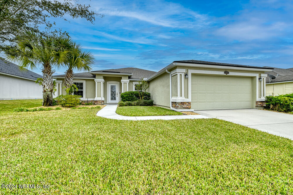 a front view of a house with a yard