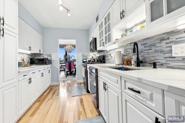 a kitchen with cabinets and wooden floor