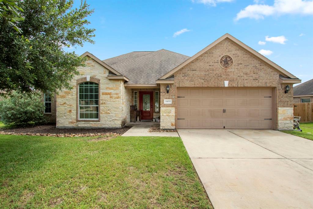 a front view of a house with a yard and garage