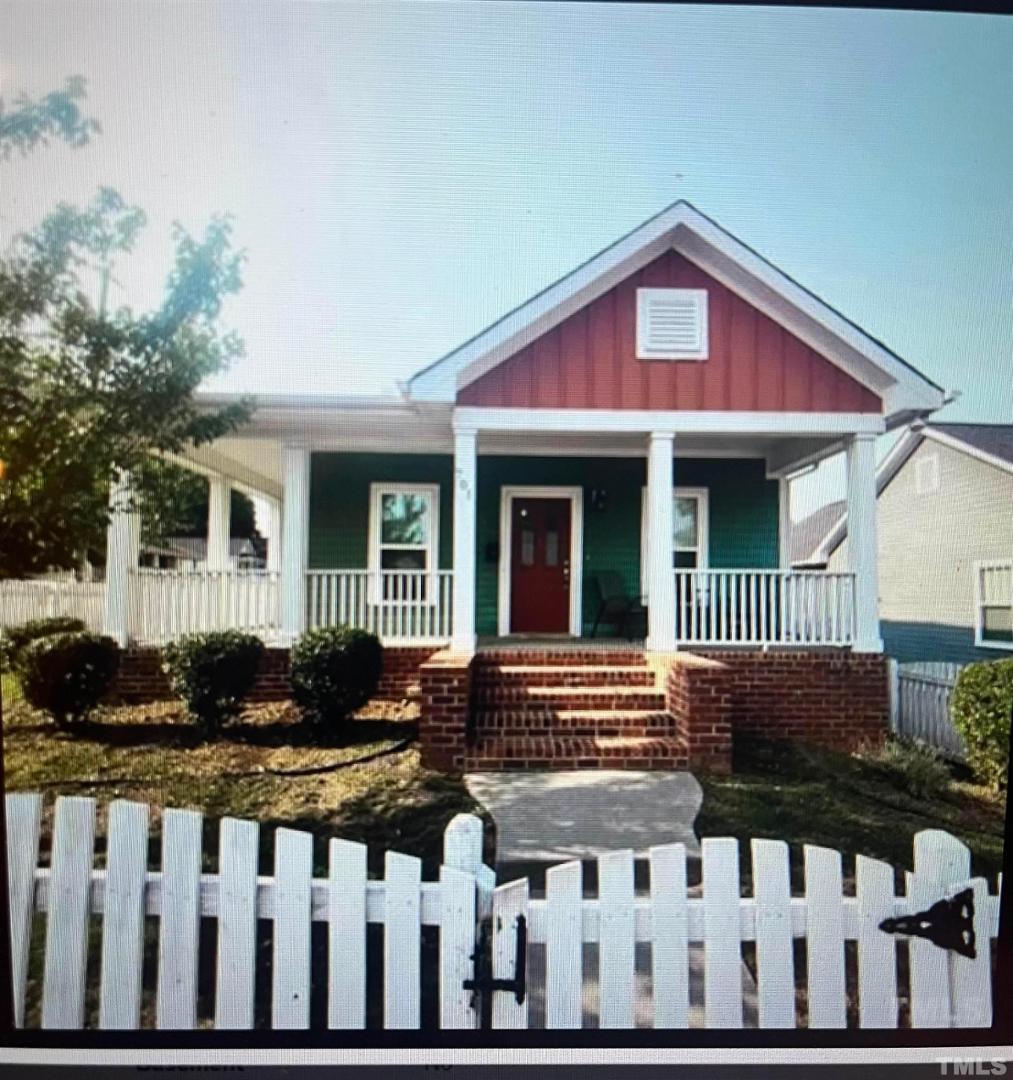 a view of a house with wooden fence