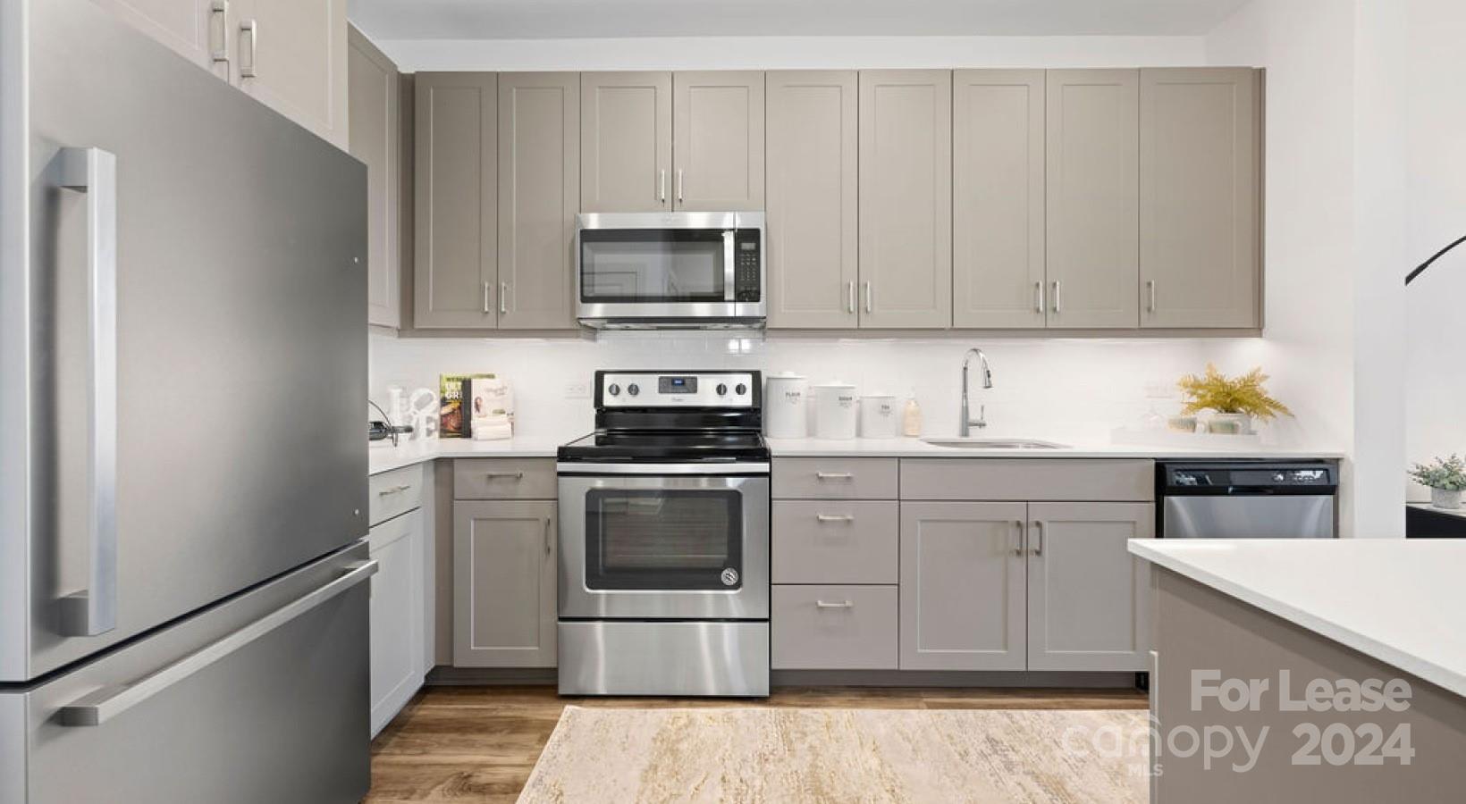 a kitchen with a sink stove and white cabinets