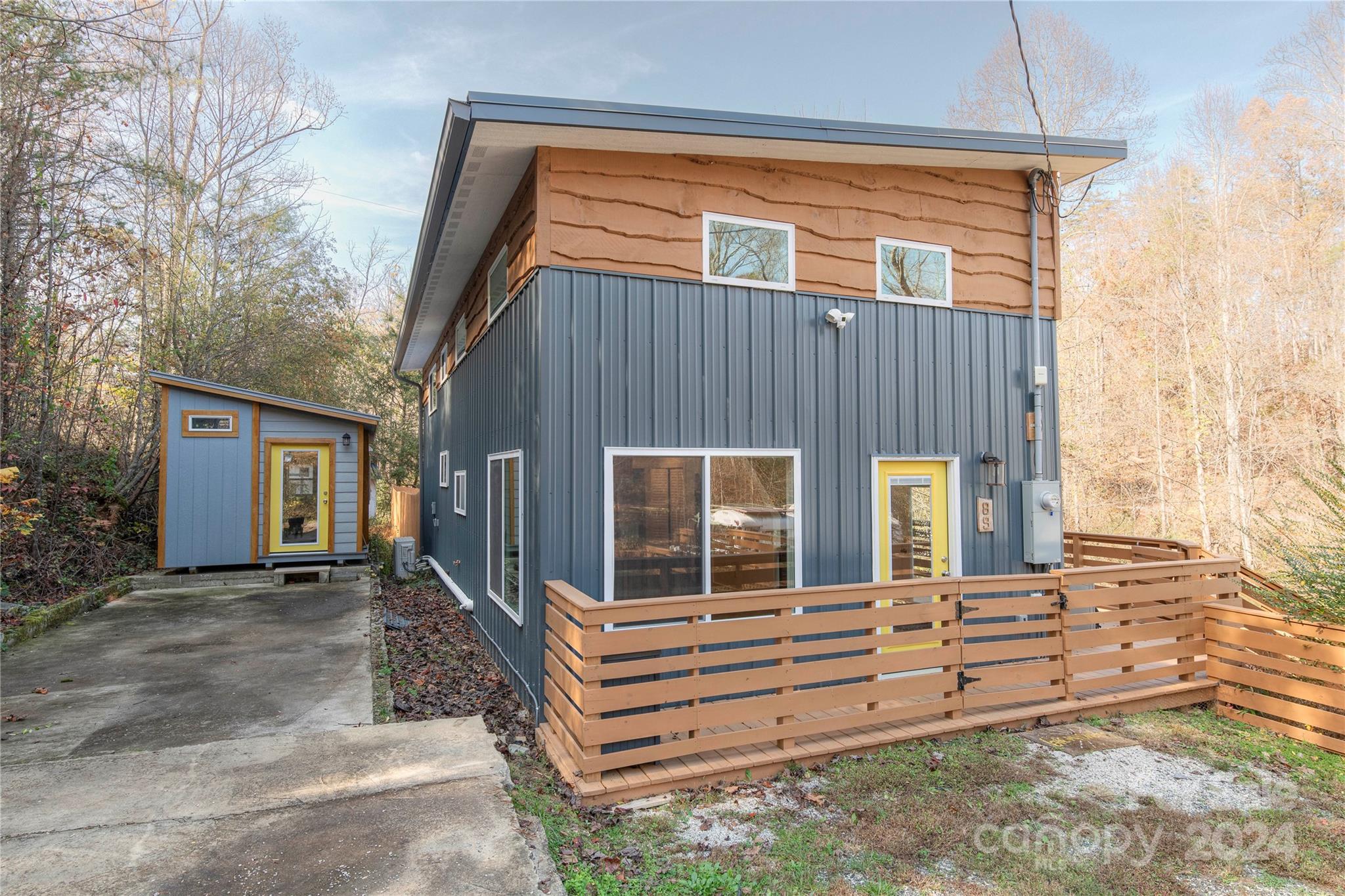 a view of house with deck and outdoor space