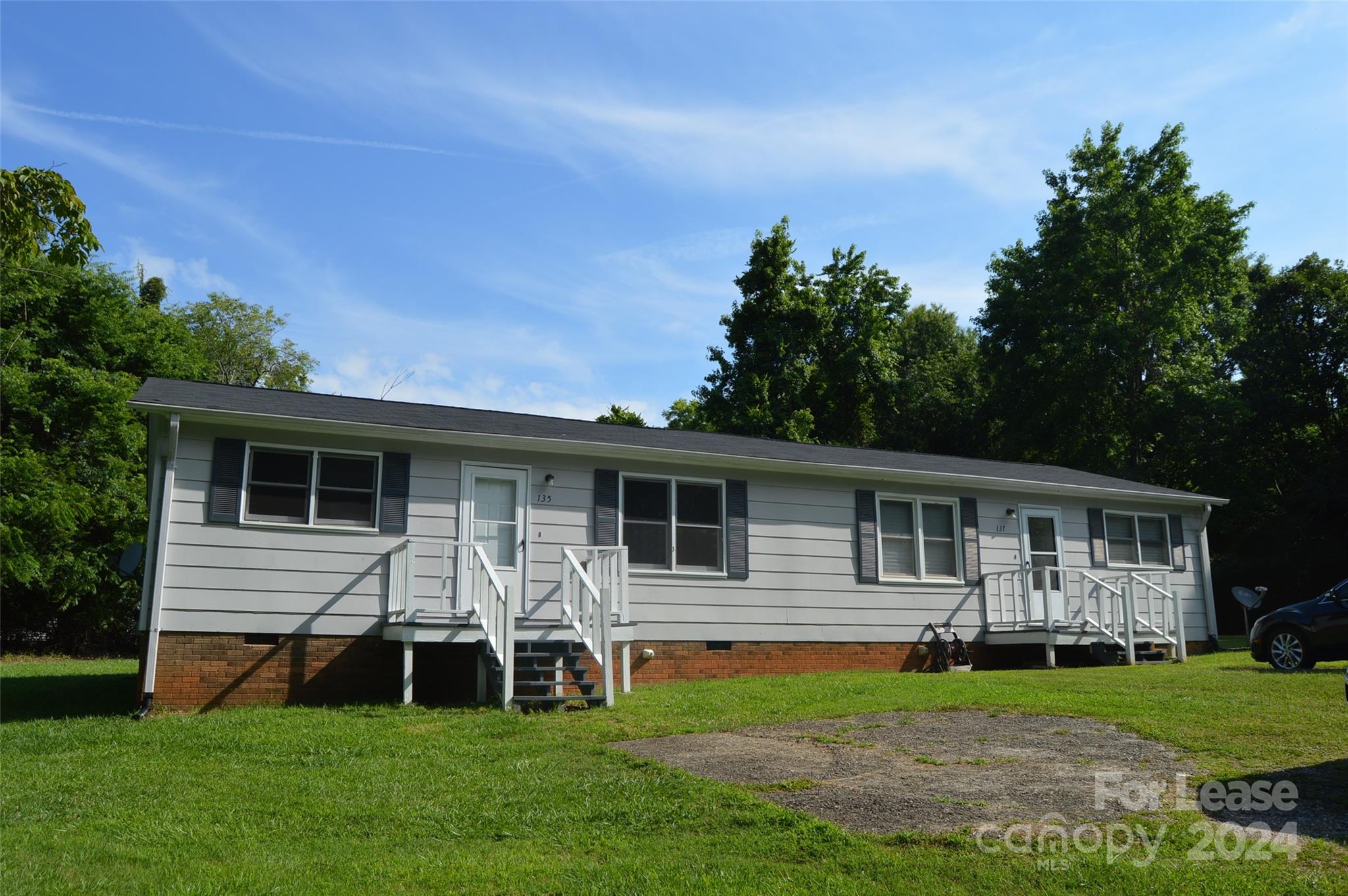 a view of a house with a yard and sitting area