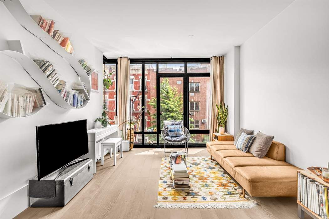 a living room with furniture tv and a flat screen tv