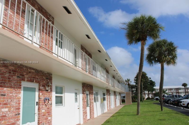 a view of a building with a yard