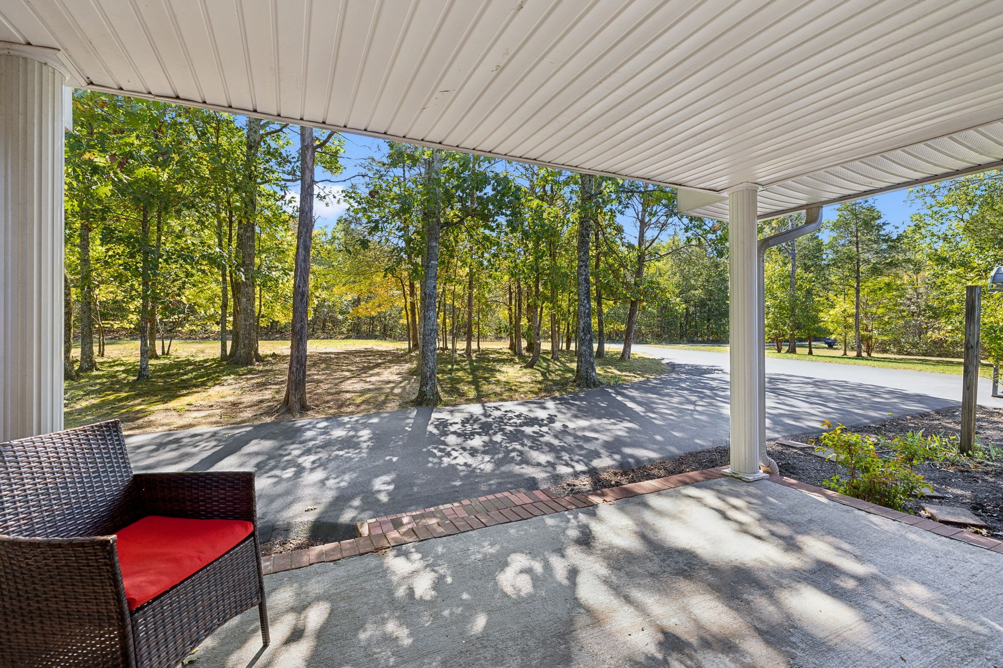 a view of a porch with chairs and backyard