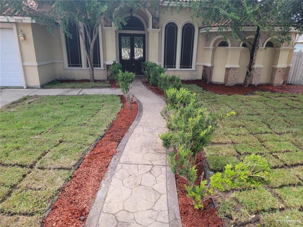 Entrance to property with a lawn