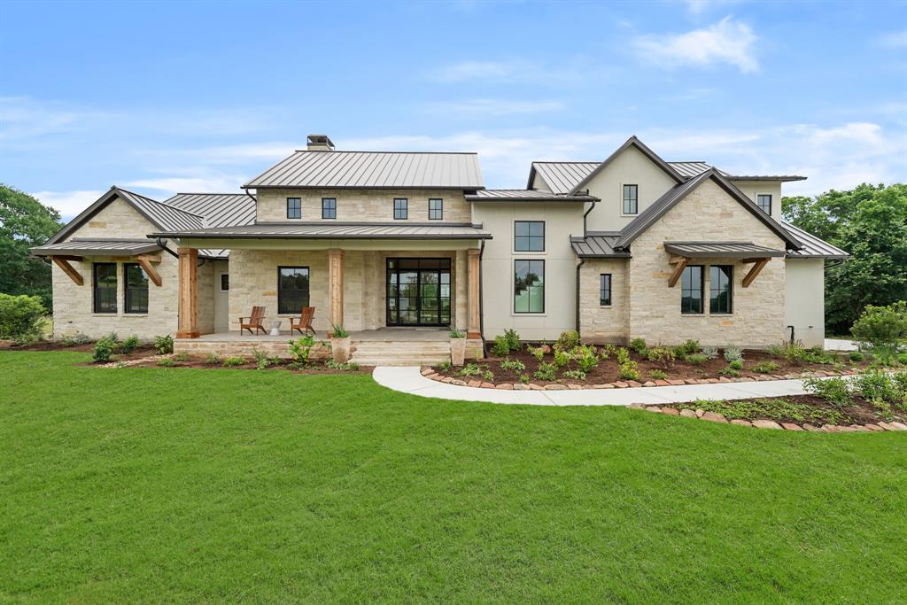 a front view of a house with swimming pool having outdoor seating